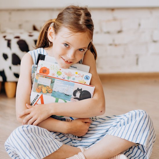 girl hugging books